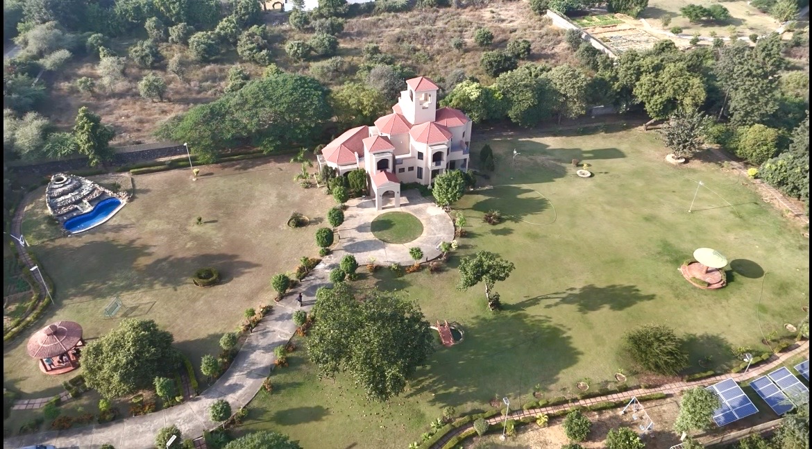 Aerial view of the estate with the pool, lawns and driveways